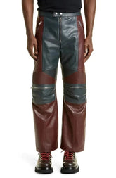 Brown and gray leather pants worn by a person on a white background
